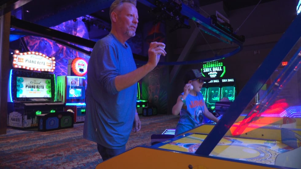 Buddy Lemann, from Baton Rouge, Louisiana, playing arcade games with his nephew.